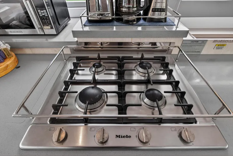 Sundecker Yacht Photos Pics Modern Miele gas stove on Leopard 45 yacht, 2021 model, with four burners and sleek design.
