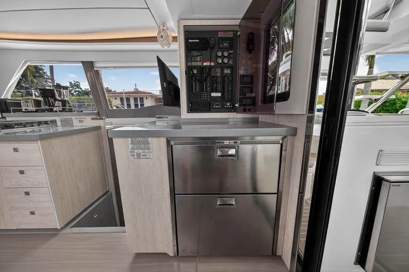 Sundecker Yacht Photos Pics Modern interior of 2021 Leopard 45 yacht with control panel and stainless steel drawers.