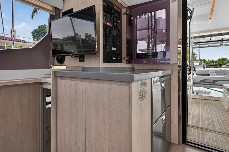 Sundecker Yacht Photos Pics Modern interior of 2021 Leopard 45 yacht with sleek cabinetry and mounted TV.