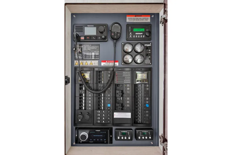 Sundecker Yacht Photos Pics Electrical control panel of a 2021 Leopard 45 yacht with various switches and gauges.