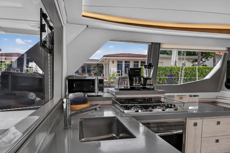 Sundecker Yacht Photos Pics Modern kitchen interior on 2021 Leopard 45 yacht, featuring appliances and sleek design.