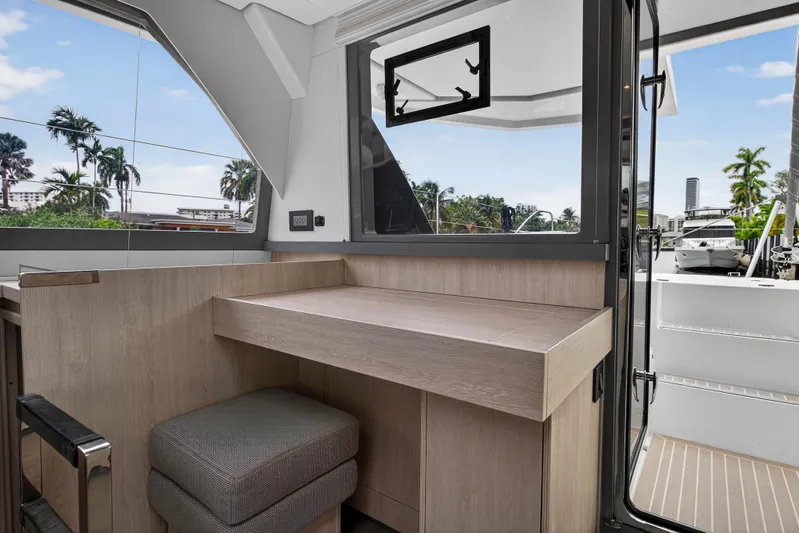 Sundecker Yacht Photos Pics Interior of 2021 Leopard 45 yacht with modern wooden desk and stool.
