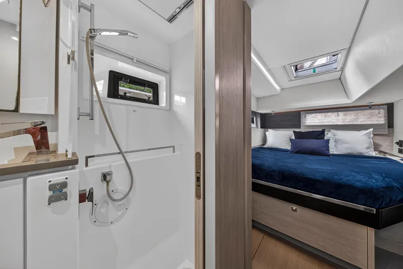 Sundecker Yacht Photos Pics Luxurious interior of 2021 Leopard 45 yacht featuring a cozy bedroom and modern bathroom.