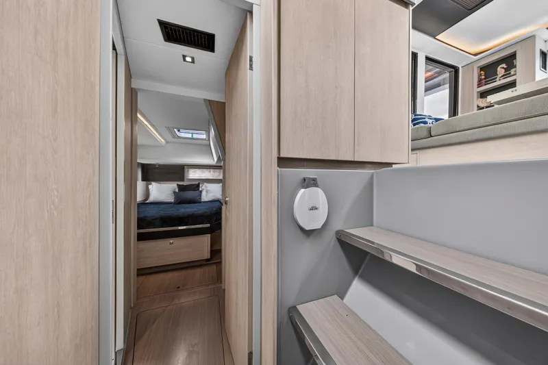 Sundecker Yacht Photos Pics Modern interior of 2021 Leopard 45 yacht, featuring a cozy bedroom and sleek wooden finishes.