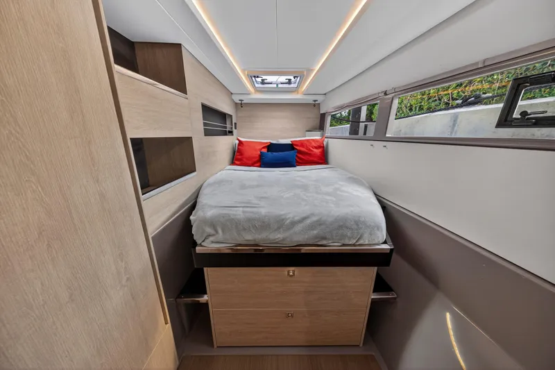 Sundecker Yacht Photos Pics Modern bedroom interior on 2021 Leopard 45 yacht with cozy bed and natural light.