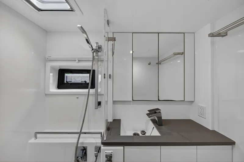 Sundecker Yacht Photos Pics Modern bathroom interior in 2021 Leopard 45 yacht, featuring sleek fixtures and mirrored cabinets.