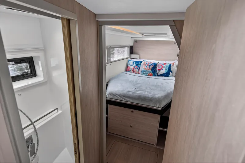 Sundecker Yacht Photos Pics Luxurious bedroom interior of 2021 Leopard 45 yacht with modern decor and cozy bedding.
