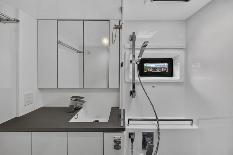 Sundecker Yacht Photos Pics Modern bathroom in 2021 Leopard 45 yacht with sleek fixtures and mirrored cabinets.