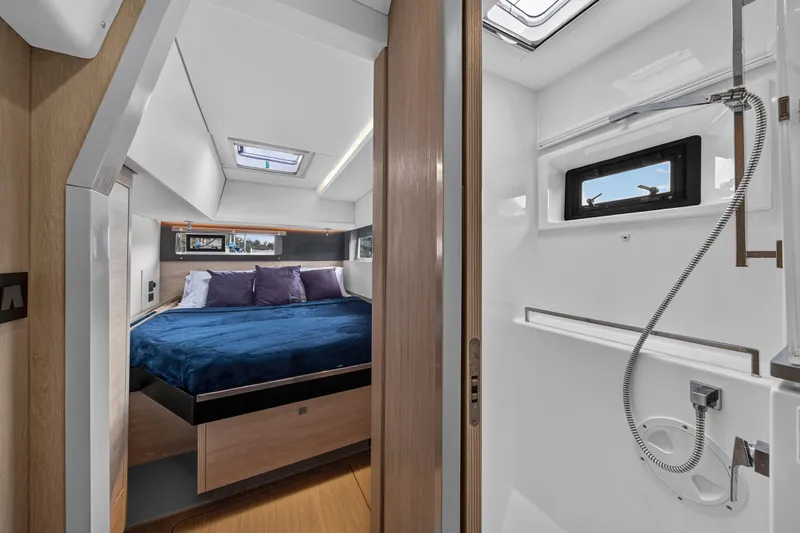 Sundecker Yacht Photos Pics Luxurious interior of 2021 Leopard 45 yacht featuring a cozy bedroom and modern bathroom.