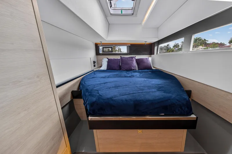 Sundecker Yacht Photos Pics Luxurious bedroom interior of 2021 Leopard 45 yacht with blue bedding and modern design.