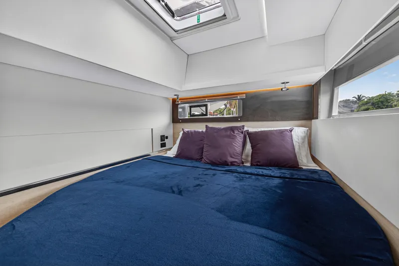 Sundecker Yacht Photos Pics Luxurious cabin interior of 2021 Leopard 45 yacht with plush bedding and modern design.