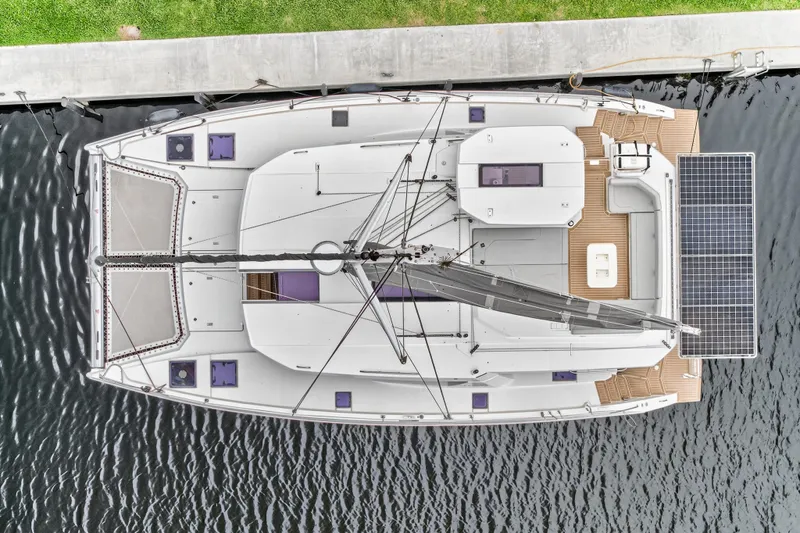 Sundecker Yacht Photos Pics Aerial view of 2021 Leopard 45 catamaran docked, featuring solar panels and spacious deck.