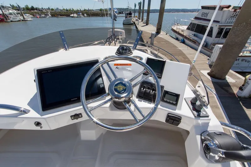  Yacht Photos Pics 2026 Ranger Tugs R-29 CB helm with modern navigation equipment at marina dock.