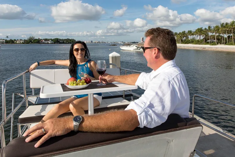  Yacht Photos Pics Couple enjoying wine and fruit on a 2026 Ranger Tugs R-29 CB boat deck.