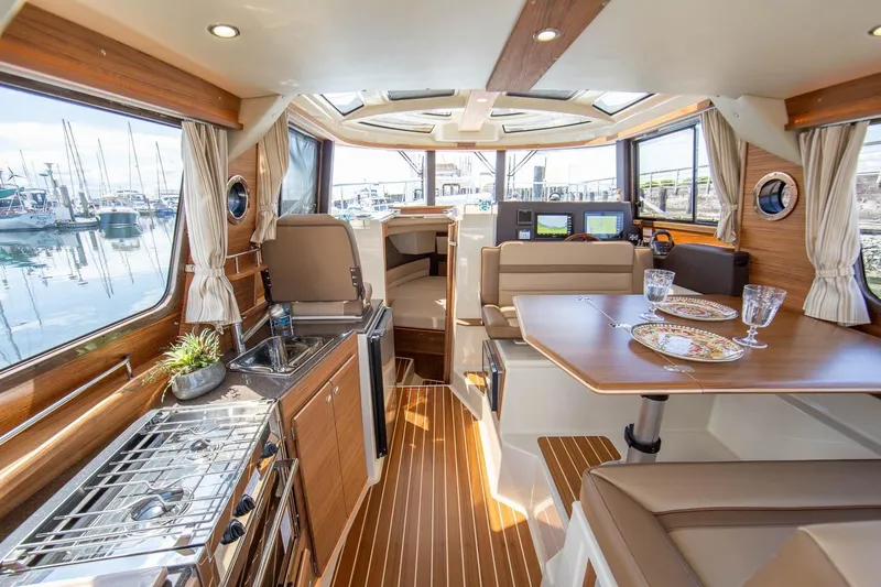  Yacht Photos Pics Luxurious interior of 2026 Ranger Tugs R-29 CB with elegant dining and kitchen area.
