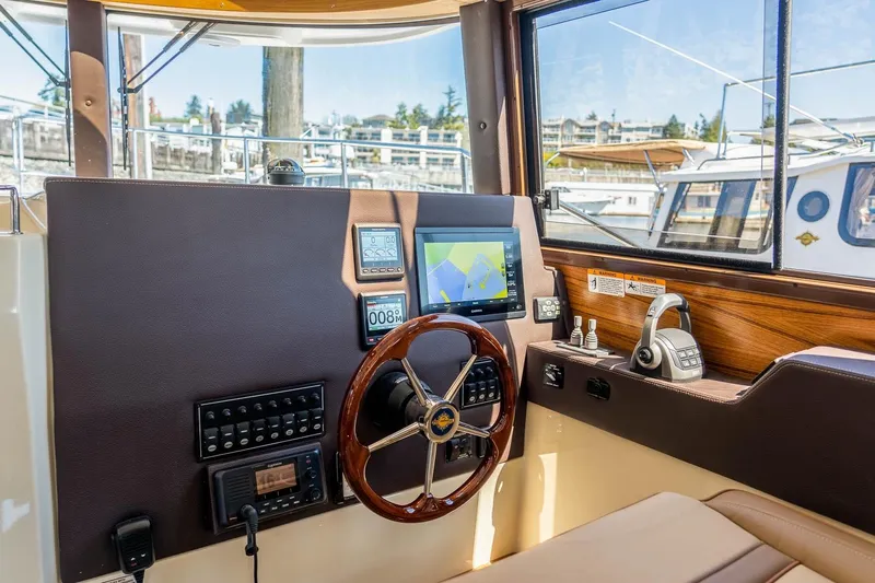  Yacht Photos Pics 2026 Ranger Tugs R-29 CB helm with navigation controls and steering wheel.