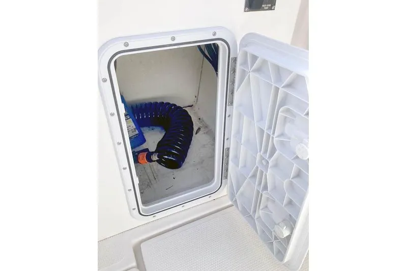  Yacht Photos Pics Storage compartment with coiled hose on 2021 Ranger Tugs R-25 boat.