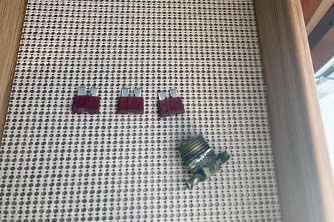  Yacht Photos Pics Three red fuses and a corroded component on a textured surface, Ranger Tugs R-25, 2021.