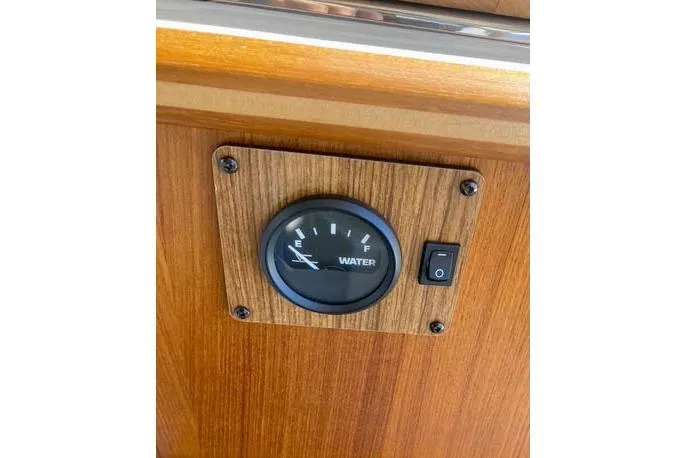  Yacht Photos Pics Water gauge and switch on 2021 Ranger Tugs R-25 boat's wooden panel.