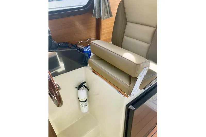  Yacht Photos Pics 2021 Ranger Tugs R-25 interior with beige seating and fire extinguisher.
