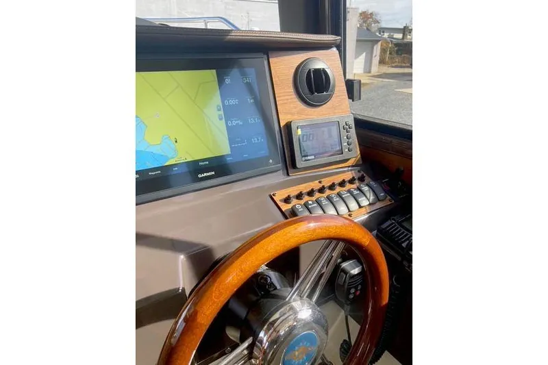  Yacht Photos Pics 2021 Ranger Tugs R-25 helm with Garmin navigation display and wooden steering wheel.
