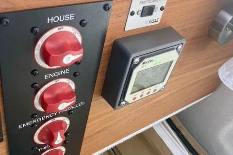  Yacht Photos Pics Control panel of a 2021 Ranger Tugs R-25 boat with red switches and a digital display.