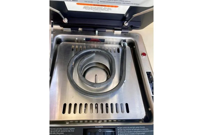  Yacht Photos Pics Stainless steel stove on 2021 Ranger Tugs R-25 boat, featuring a coiled heating element.