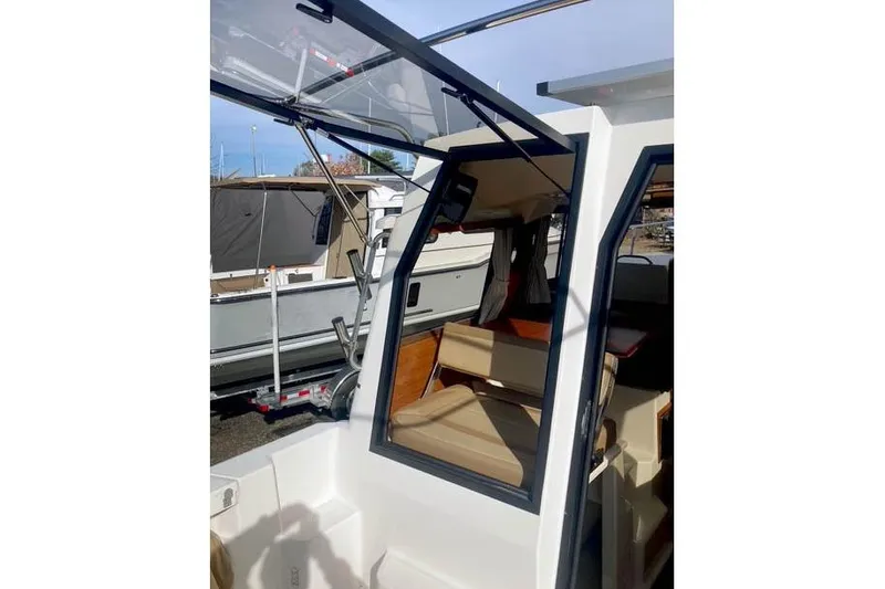  Yacht Photos Pics 2021 Ranger Tugs R-25 boat interior with open cabin door and seating area.