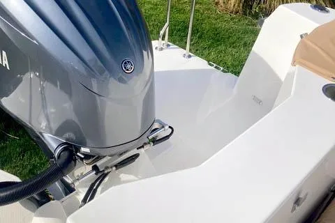  Yacht Photos Pics 2021 Ranger Tugs R-25 boat with Yamaha outboard motor, docked on grass.