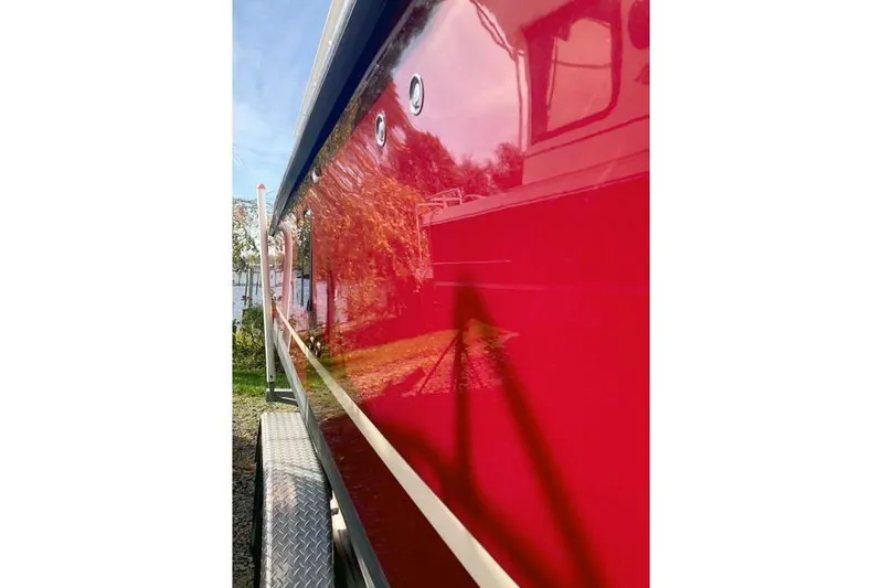  Yacht Photos Pics 2021 Ranger Tugs R-25 boat with glossy red exterior, side view.