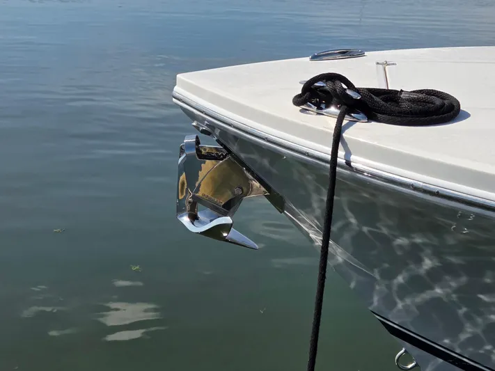 No Name Yacht Photos Pics 2021 Regulator 31 CC boat bow with anchor and rope on calm water.