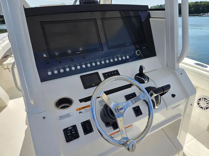 No Name Yacht Photos Pics 2021 Regulator 31 CC boat dashboard with steering wheel and electronic controls.
