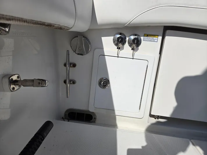 No Name Yacht Photos Pics 2021 Regulator 31 CC boat interior with storage compartment and metal fixtures.