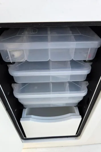 No Name Yacht Photos Pics Storage compartments on a 2021 Regulator 31 CC boat, featuring organized plastic containers.