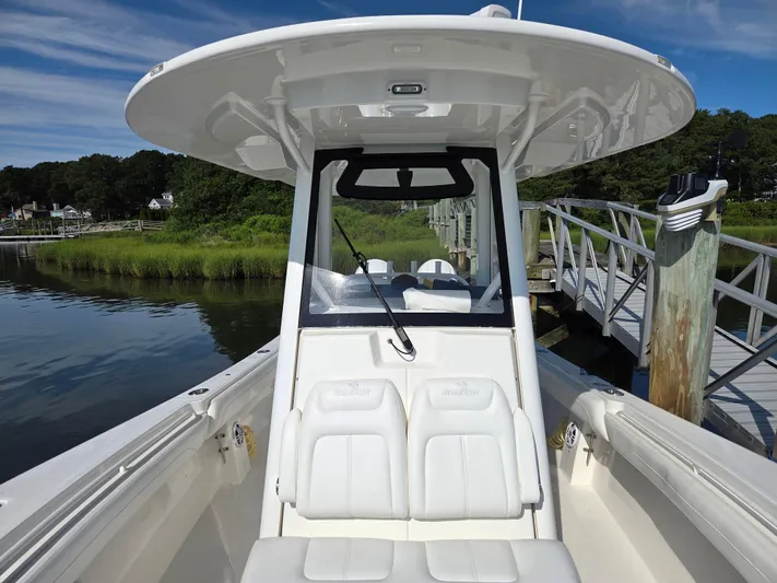 No Name Yacht Photos Pics 2021 Regulator 31 CC boat docked by a scenic waterfront.