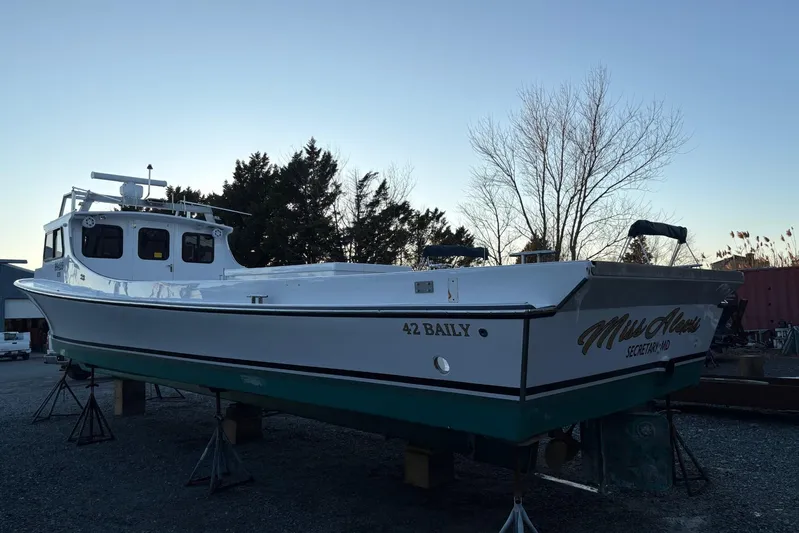  Yacht Photos Pics Custom 1994 workboat "Miss Alexis" on stands, with trees in the background.