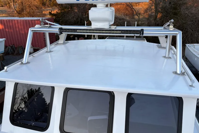  Yacht Photos Pics Custom 1994 workboat with metal roof rack and radar, docked near red container.