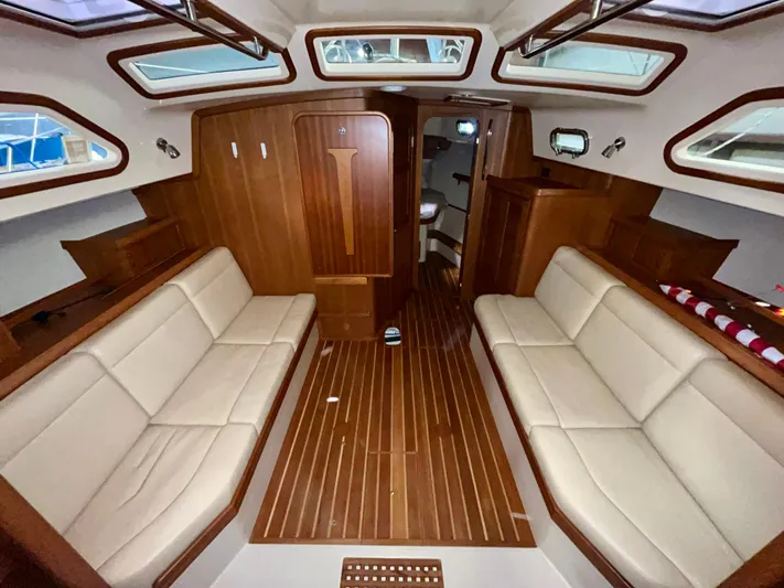 Intrepid II Yacht Photos Pics Luxurious interior of 2008 Island Packet 465 yacht with wooden finishes and beige seating.