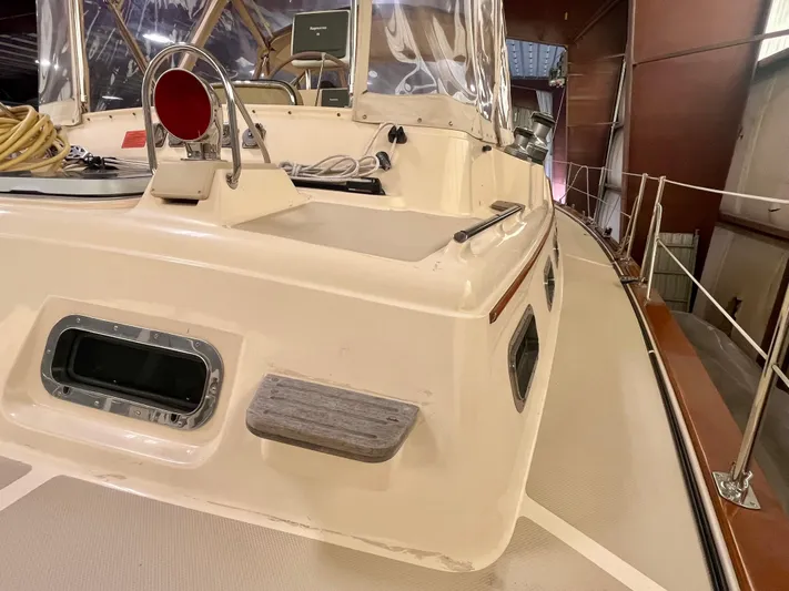 Intrepid II Yacht Photos Pics 2008 Island Packet 465 yacht deck, featuring navigation equipment and safety railings in a storage facility.