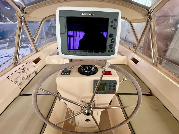 Intrepid II Yacht Photos Pics Helm of 2008 Island Packet 465 sailboat with navigation equipment and steering wheel.