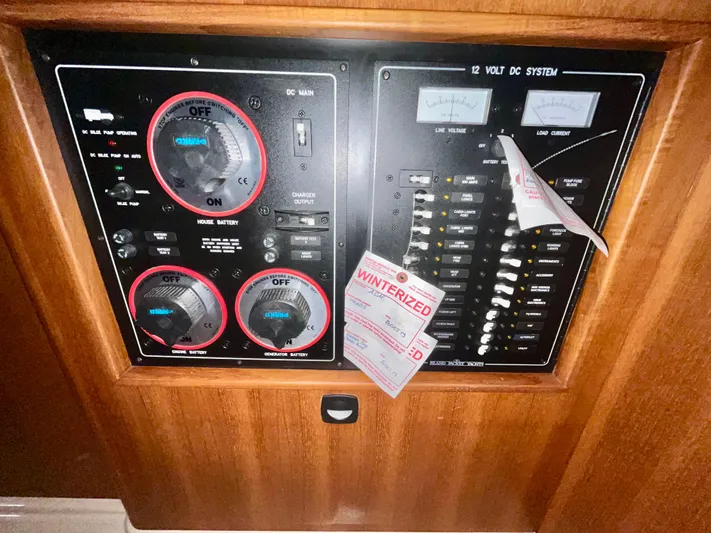 Intrepid II Yacht Photos Pics Electrical panel of a 2008 Island Packet 465 yacht, featuring battery controls and winterization tags.