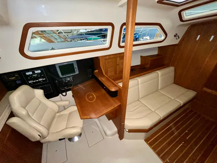 Intrepid II Yacht Photos Pics Interior of 2008 Island Packet 465 yacht with seating, navigation equipment, and wooden accents.
