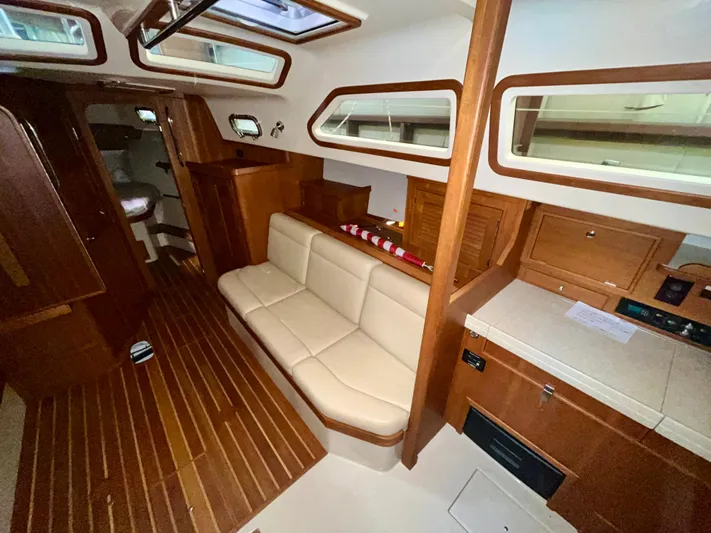 Intrepid II Yacht Photos Pics Interior of 2008 Island Packet 465 yacht with wooden finish and beige seating.