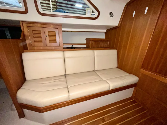 Intrepid II Yacht Photos Pics Luxurious interior of 2008 Island Packet 465 yacht with cream leather seating and wooden cabinetry.
