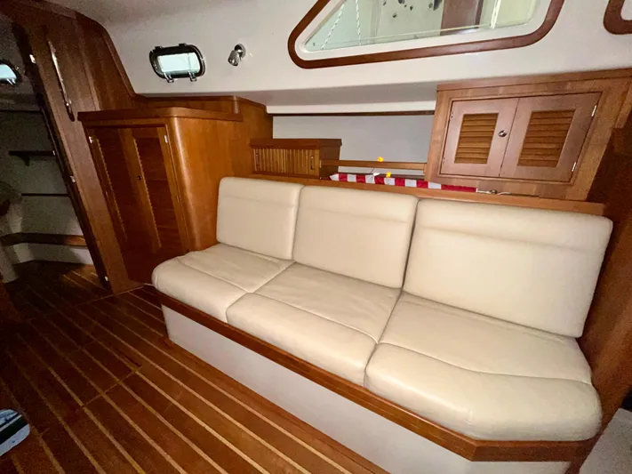 Intrepid II Yacht Photos Pics Interior of 2008 Island Packet 465 yacht with beige seating and wooden cabinetry.