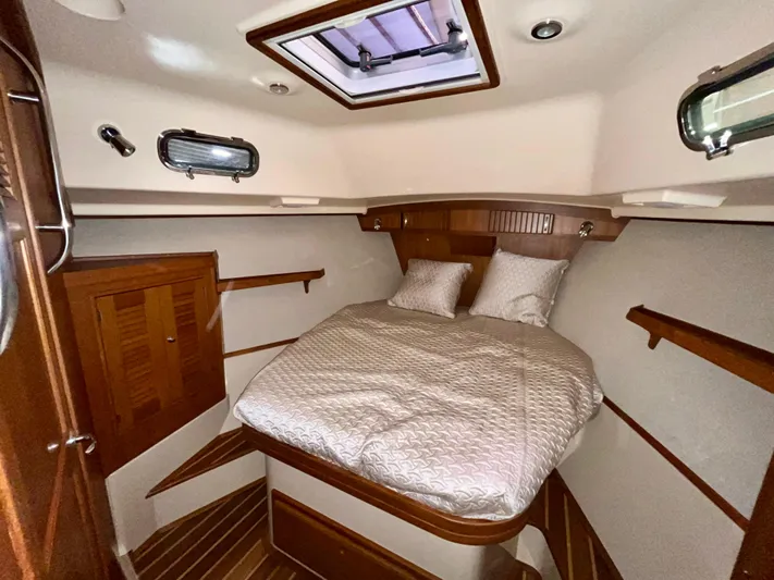 Intrepid II Yacht Photos Pics Luxurious cabin interior of 2008 Island Packet 465 yacht with cozy bed and wooden accents.