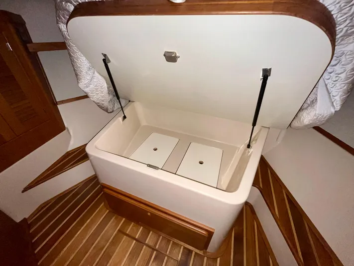 Intrepid II Yacht Photos Pics Open storage compartment on 2008 Island Packet 465 yacht with wooden flooring.