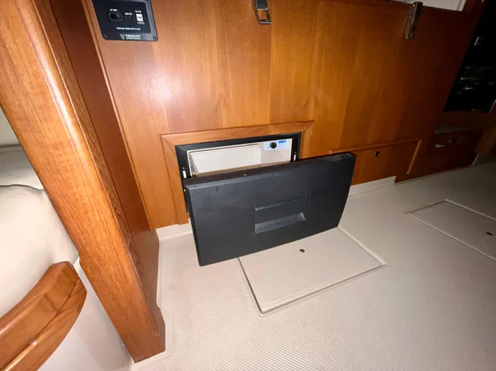 Intrepid II Yacht Photos Pics 2008 Island Packet 465 interior with open safe, wooden cabinetry, and control panel.
