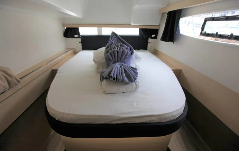 La Mer Kat Yacht Photos Pics Cozy cabin interior of 2016 Fountaine Pajot Lucia 40 catamaran with neatly arranged bed.