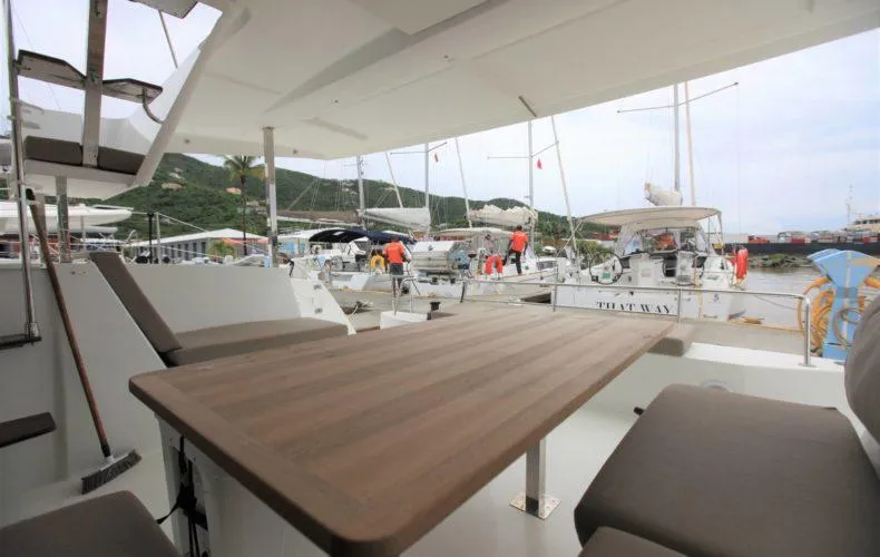 La Mer Kat Yacht Photos Pics 2016 Fountaine Pajot Lucia 40 catamaran with outdoor seating, docked at a marina.